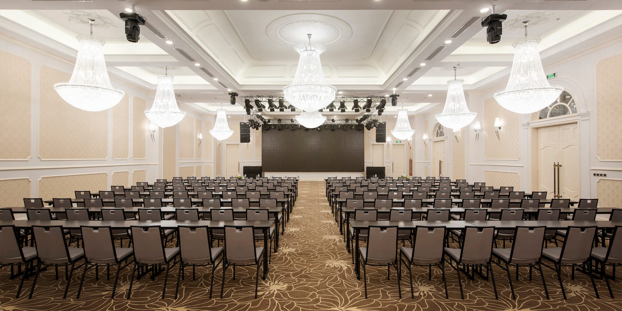 a room with chairs and chandeliers