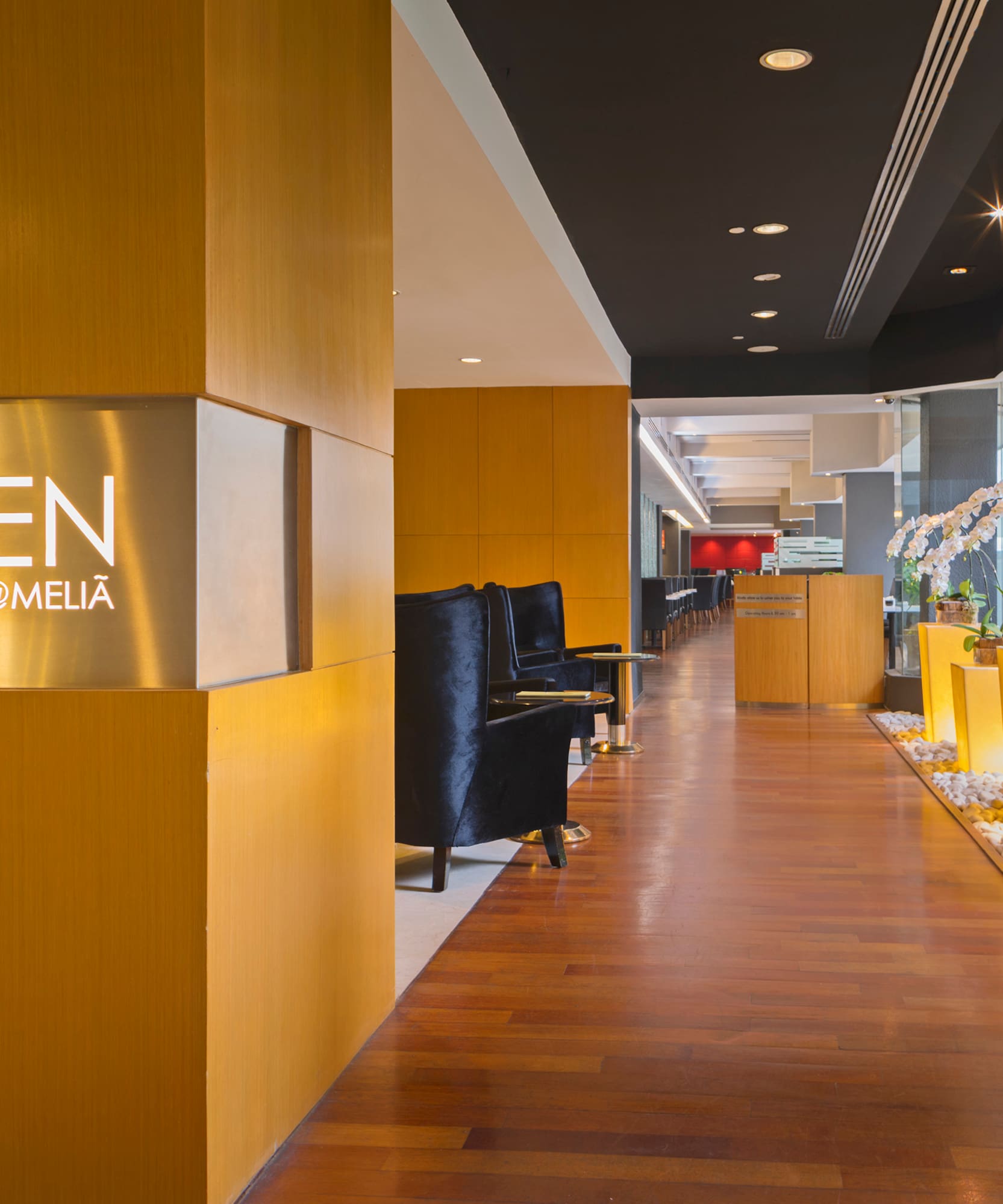 a lobby with a sign and plants