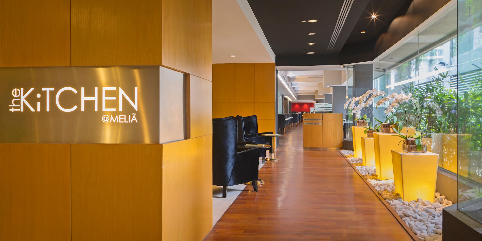 a lobby with a sign and plants