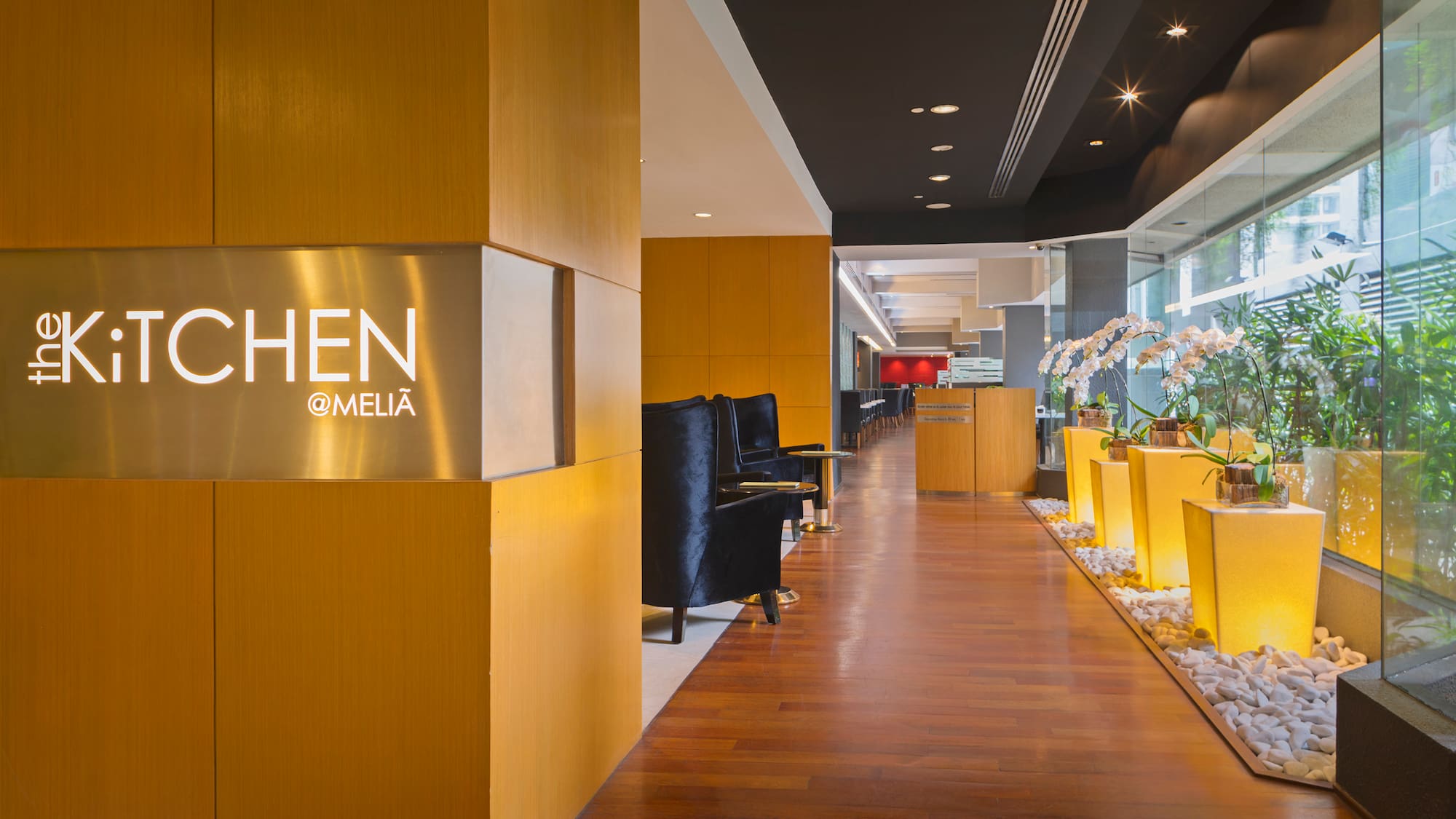 a lobby with a sign and plants