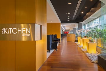 a lobby with a sign and plants