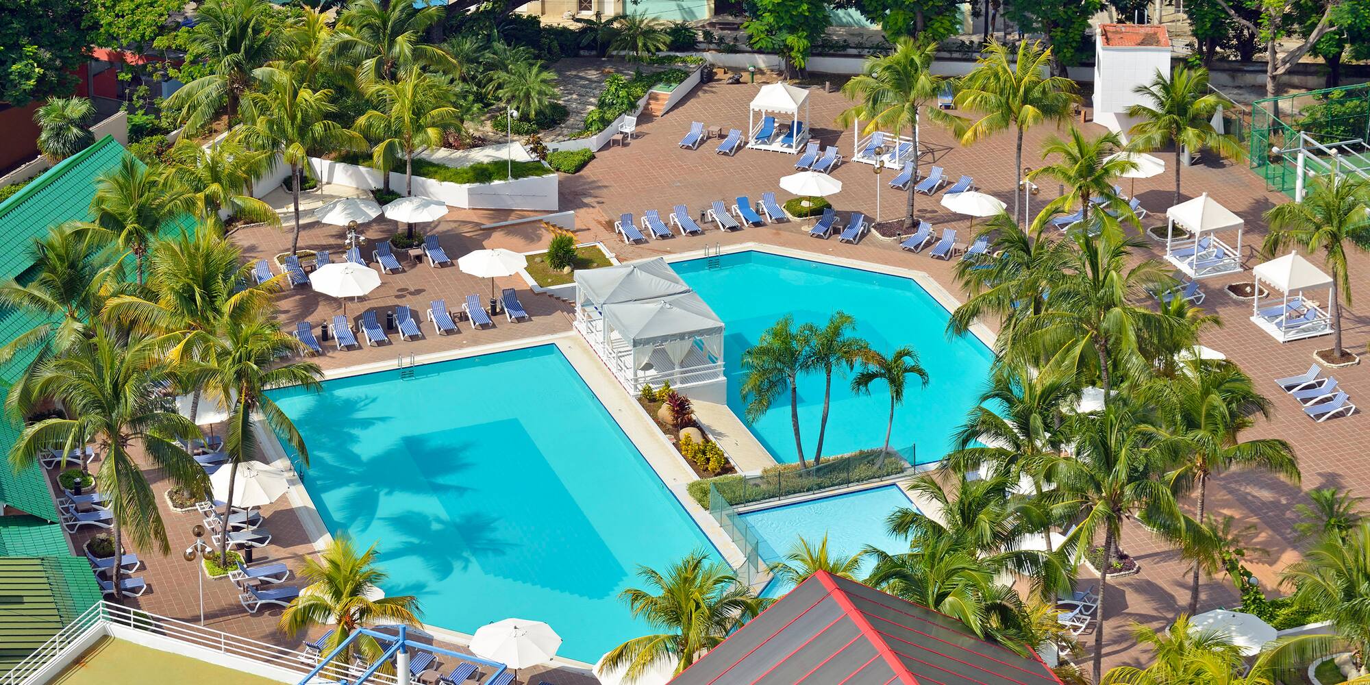 a swimming pool with umbrellas and chairs