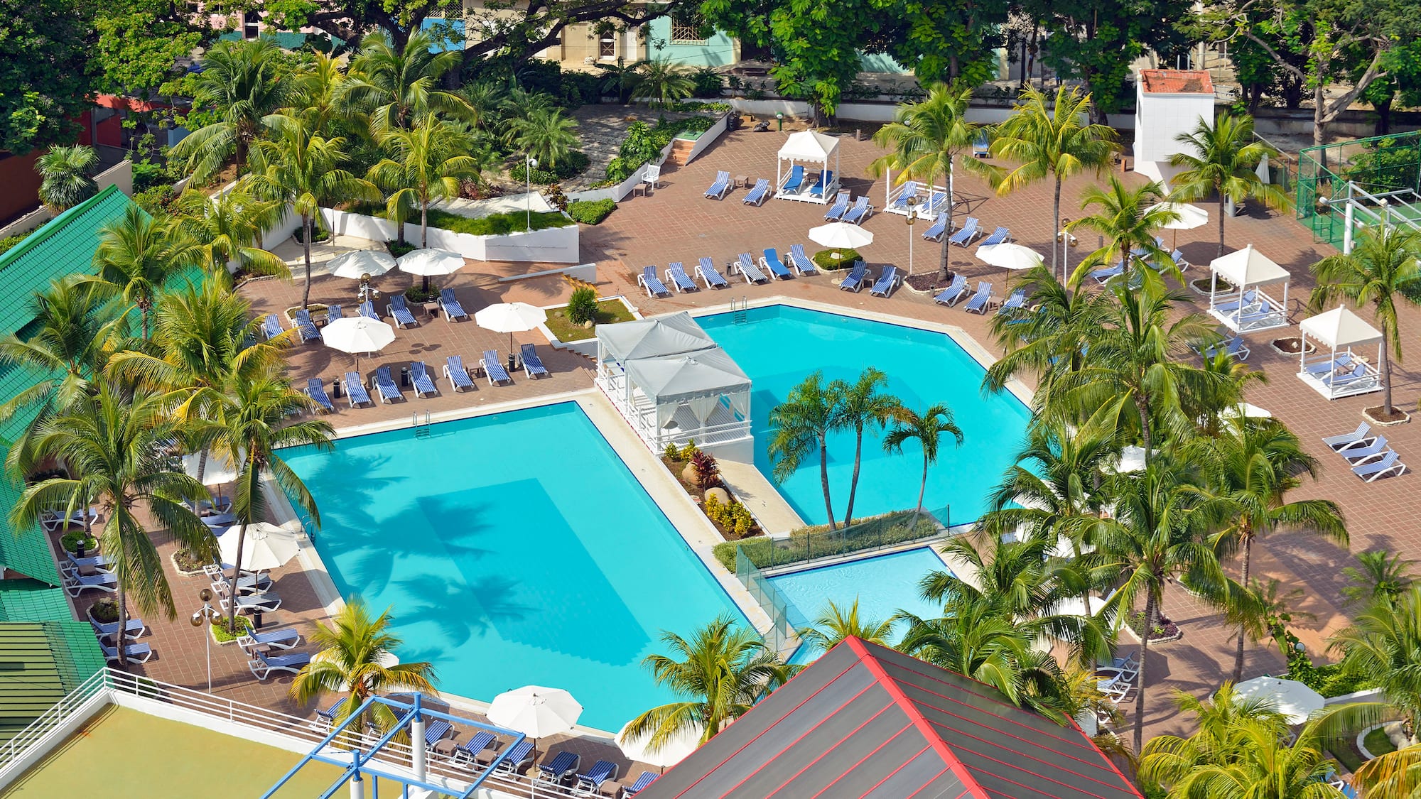 a swimming pool with umbrellas and chairs
