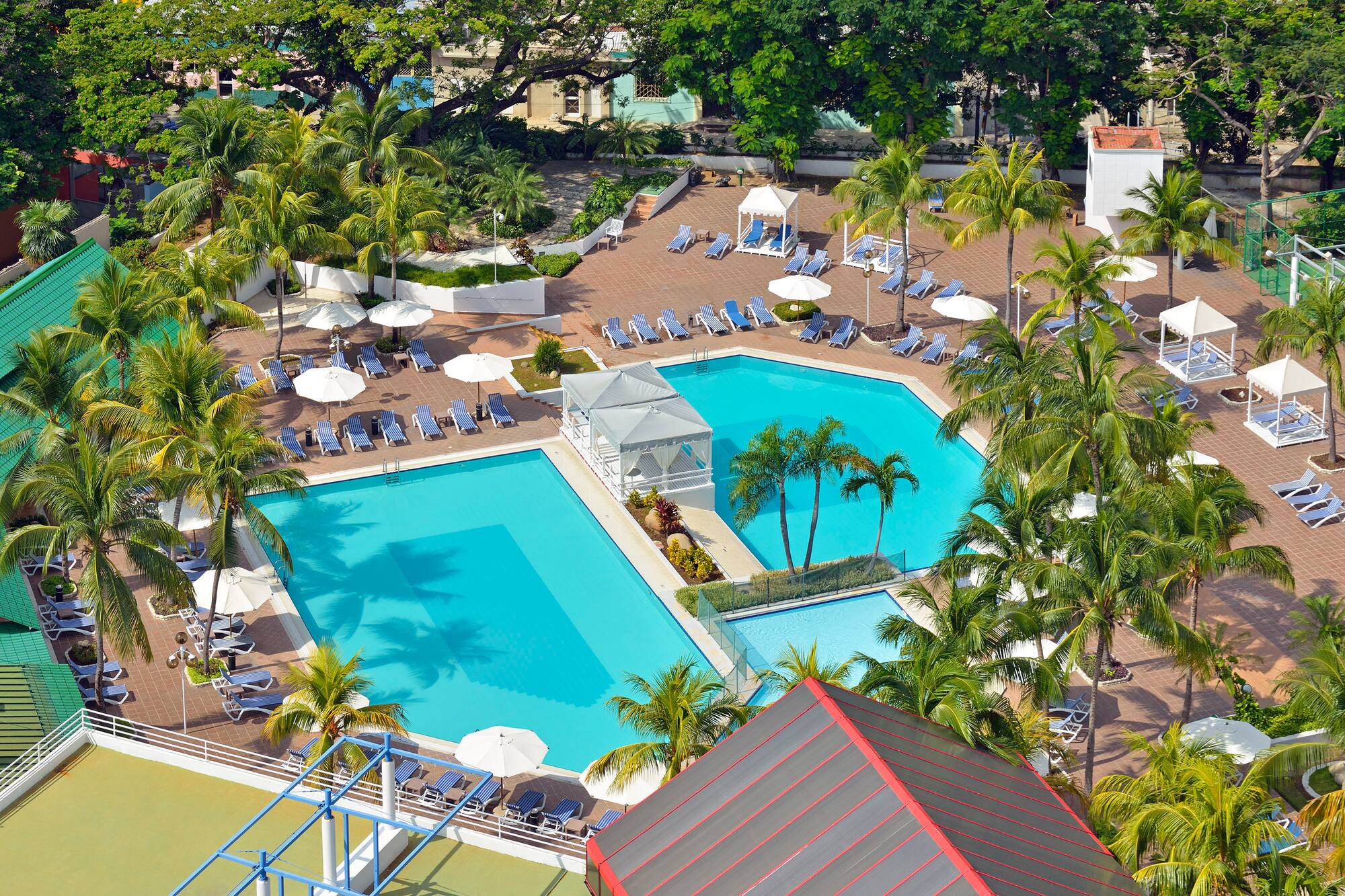 a swimming pool with umbrellas and chairs