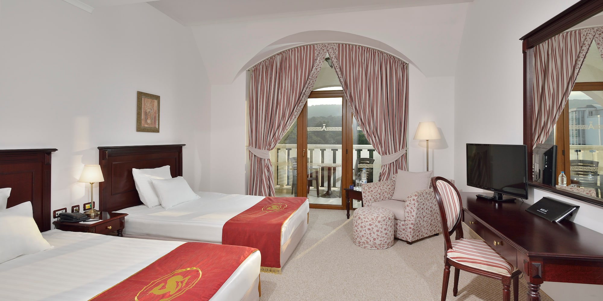 a room with two beds and a television