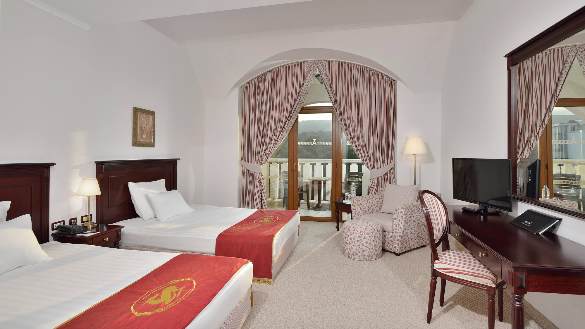 a room with two beds and a television