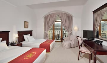 a room with two beds and a television