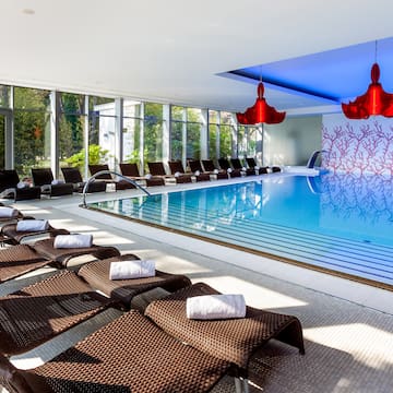 a pool with chairs and chairs in a room