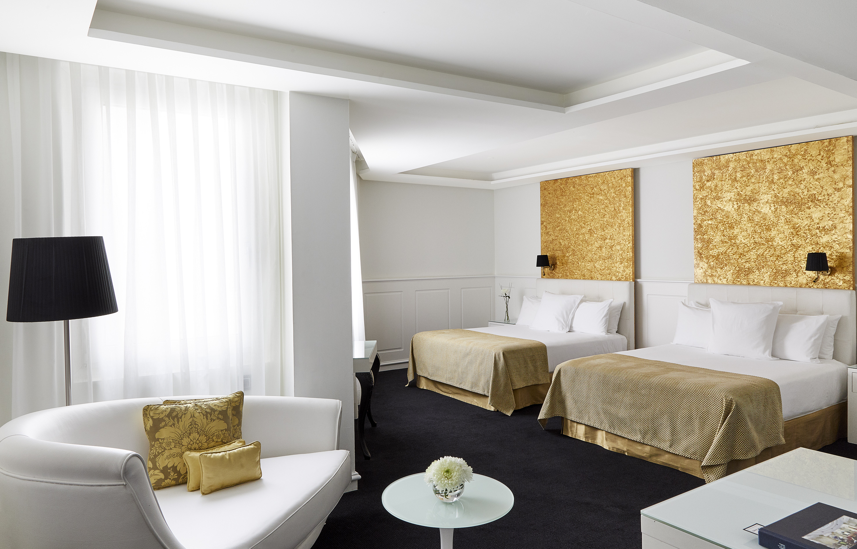 a room with two beds and a table