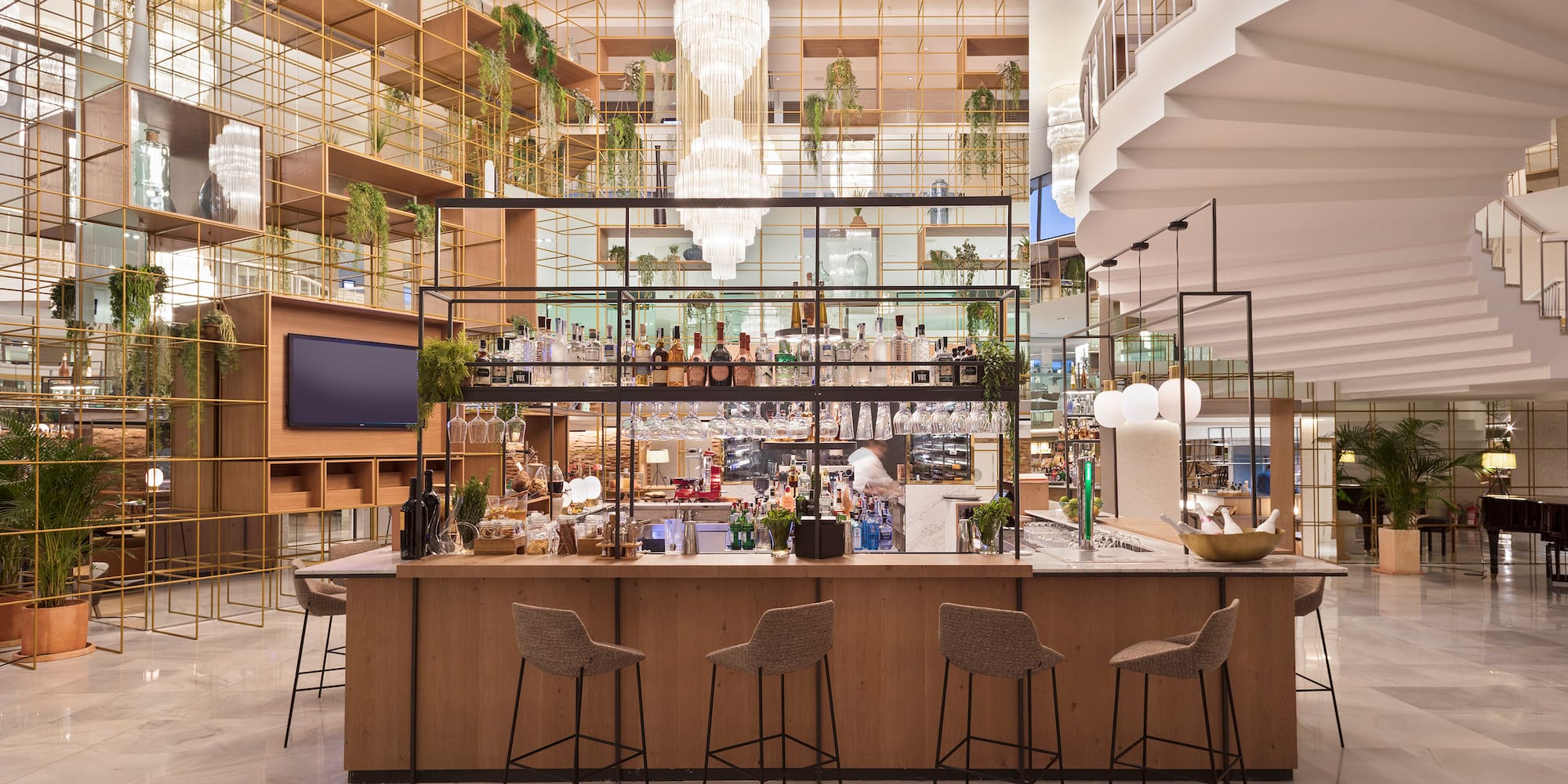 a bar with chairs and a staircase