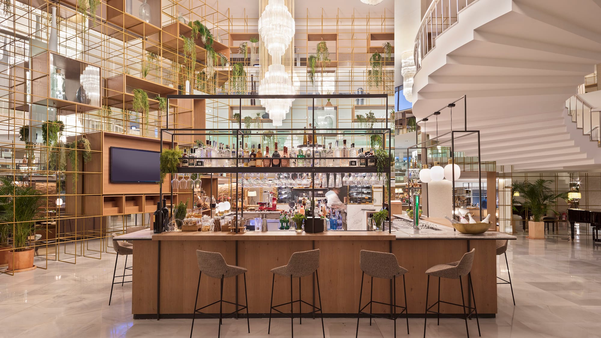 a bar with chairs and a staircase