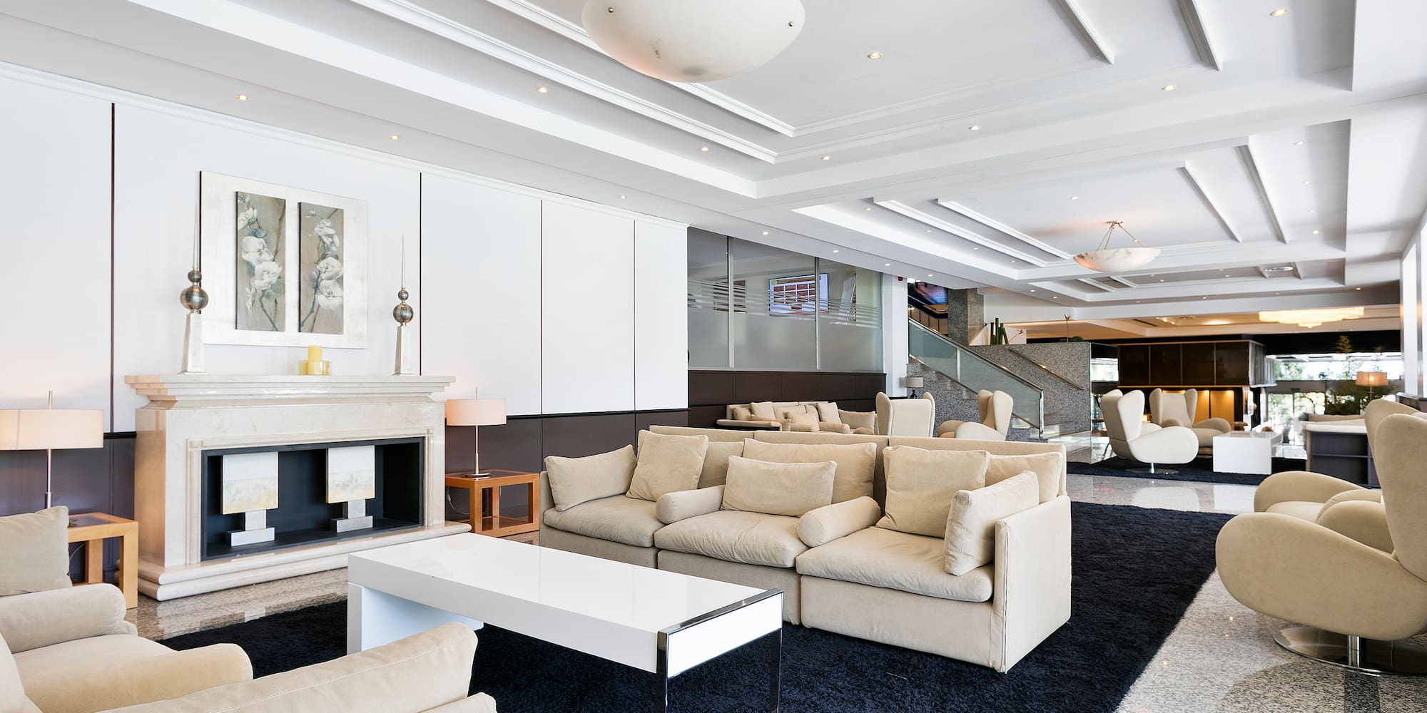 a room with white furniture and a fireplace