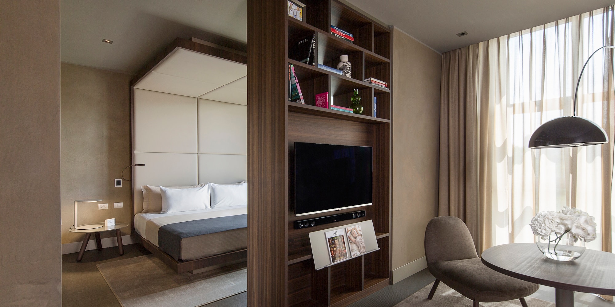 a room with a tv and a bed