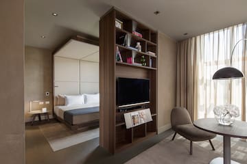 a room with a tv and a bed
