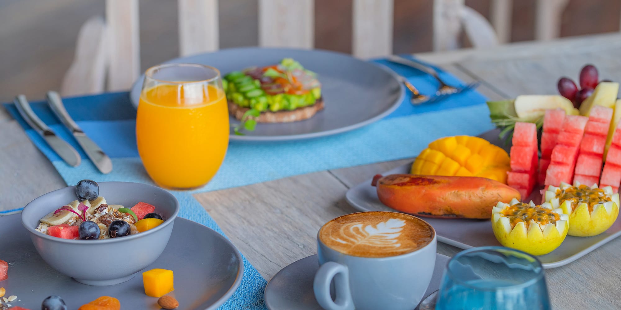 a table with plates of food and drinks