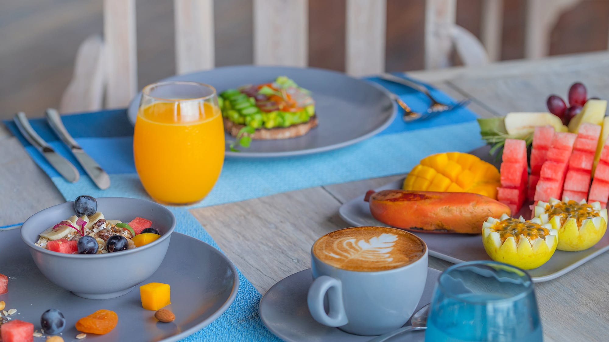 a table with plates of food and drinks