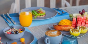 a table with plates of food and drinks