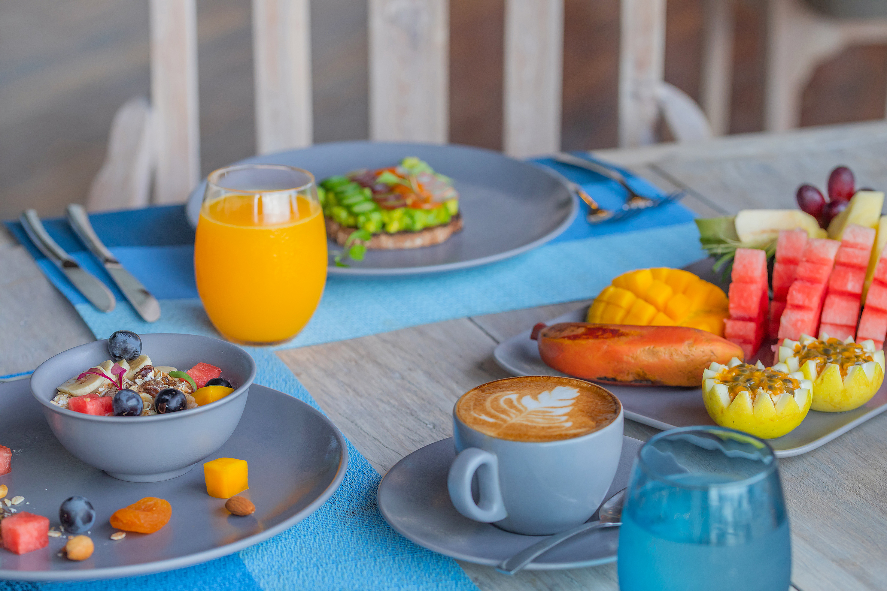 a table with plates of food and drinks