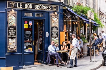 a group of people outside a restaurant