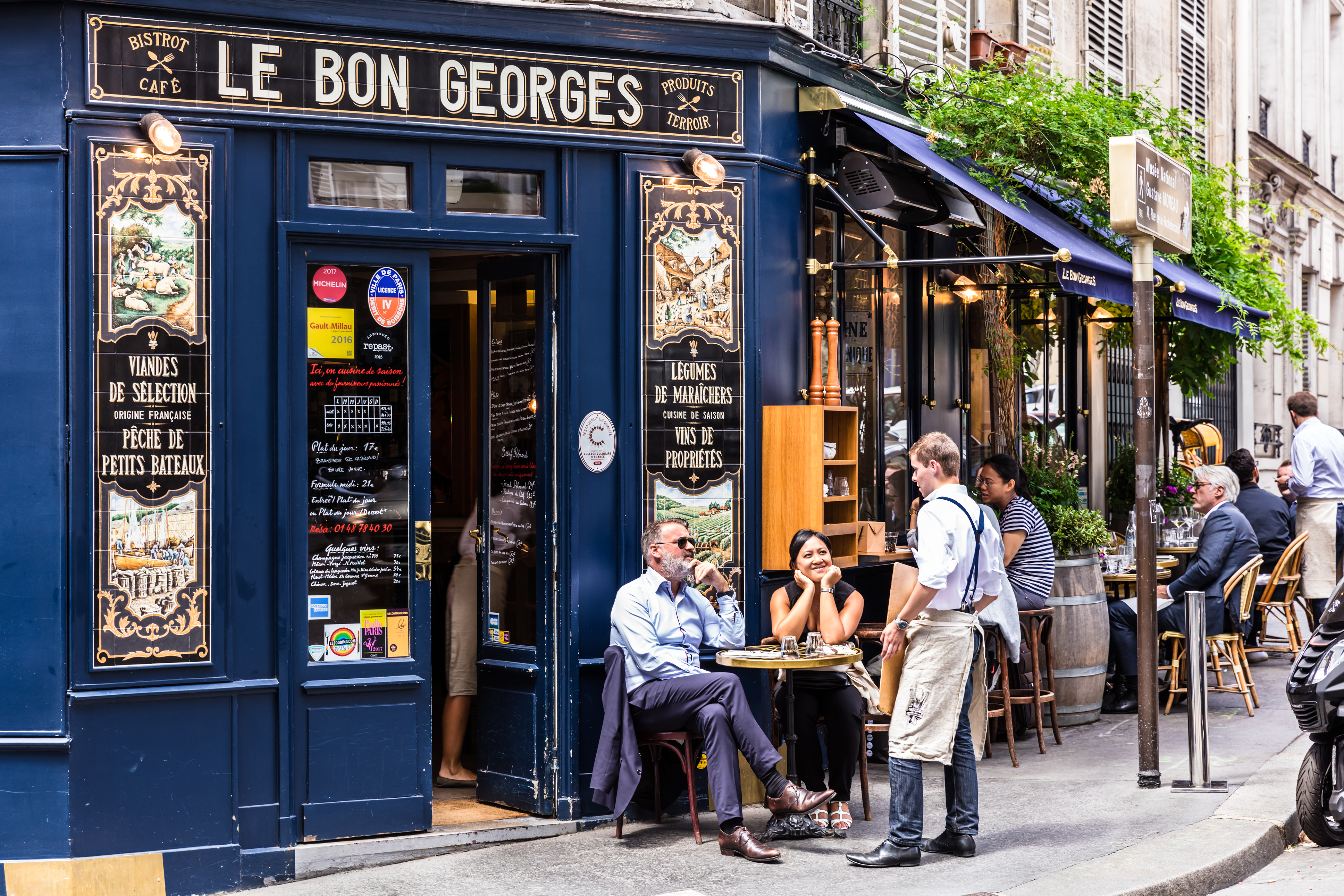a group of people outside a restaurant