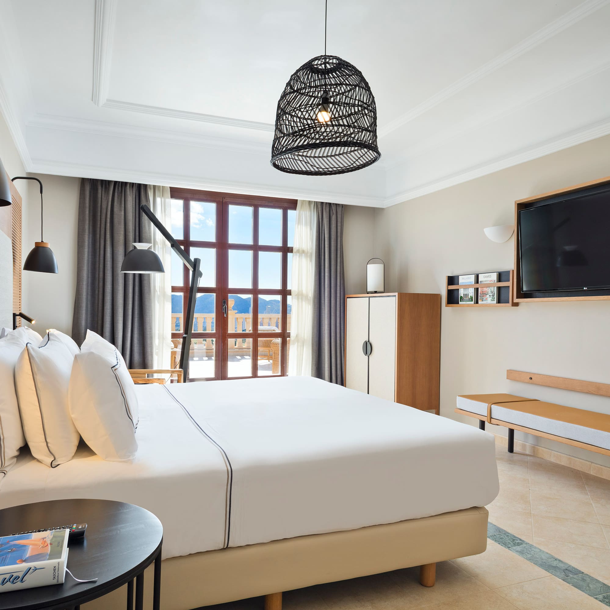 a bedroom with a large bed and a television