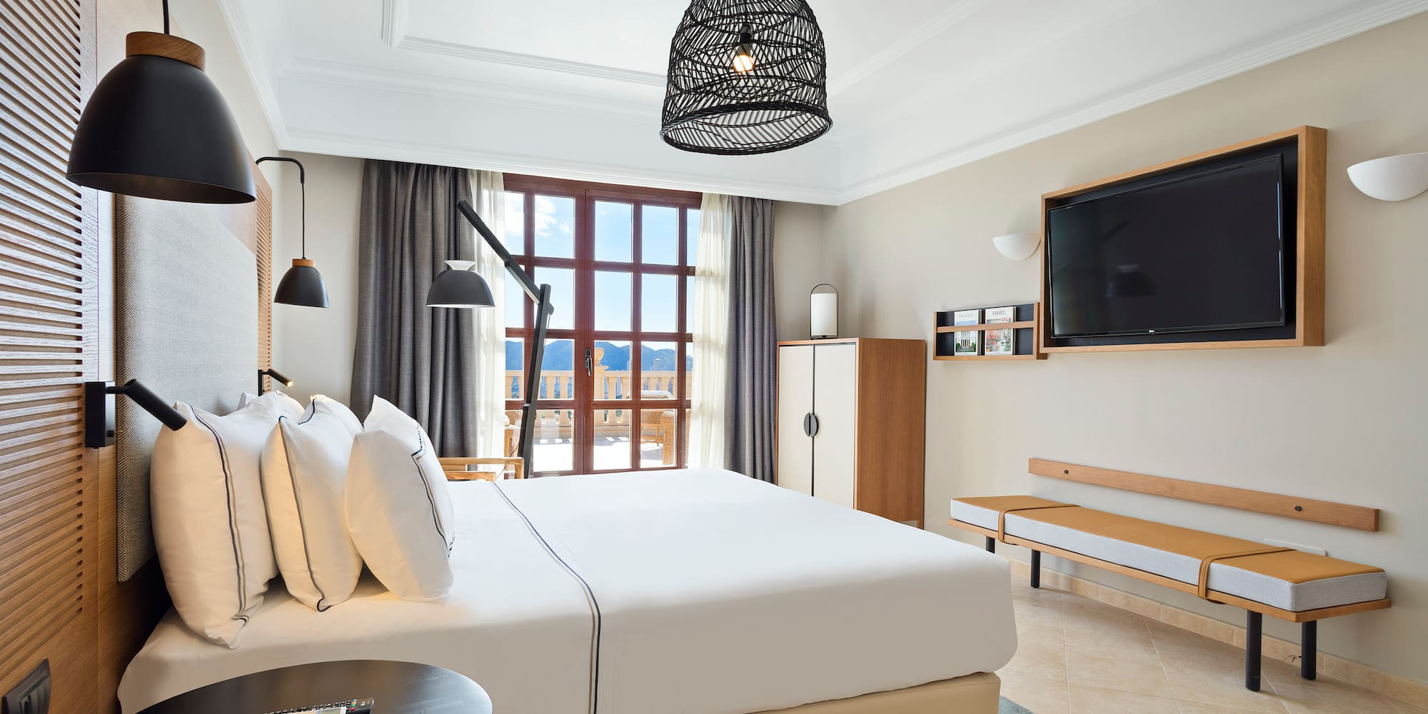 a bedroom with a large bed and a television