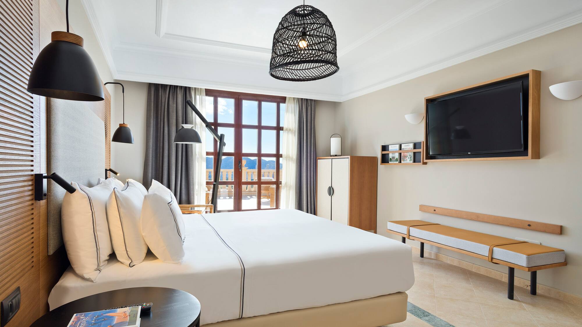 a bedroom with a large bed and a television