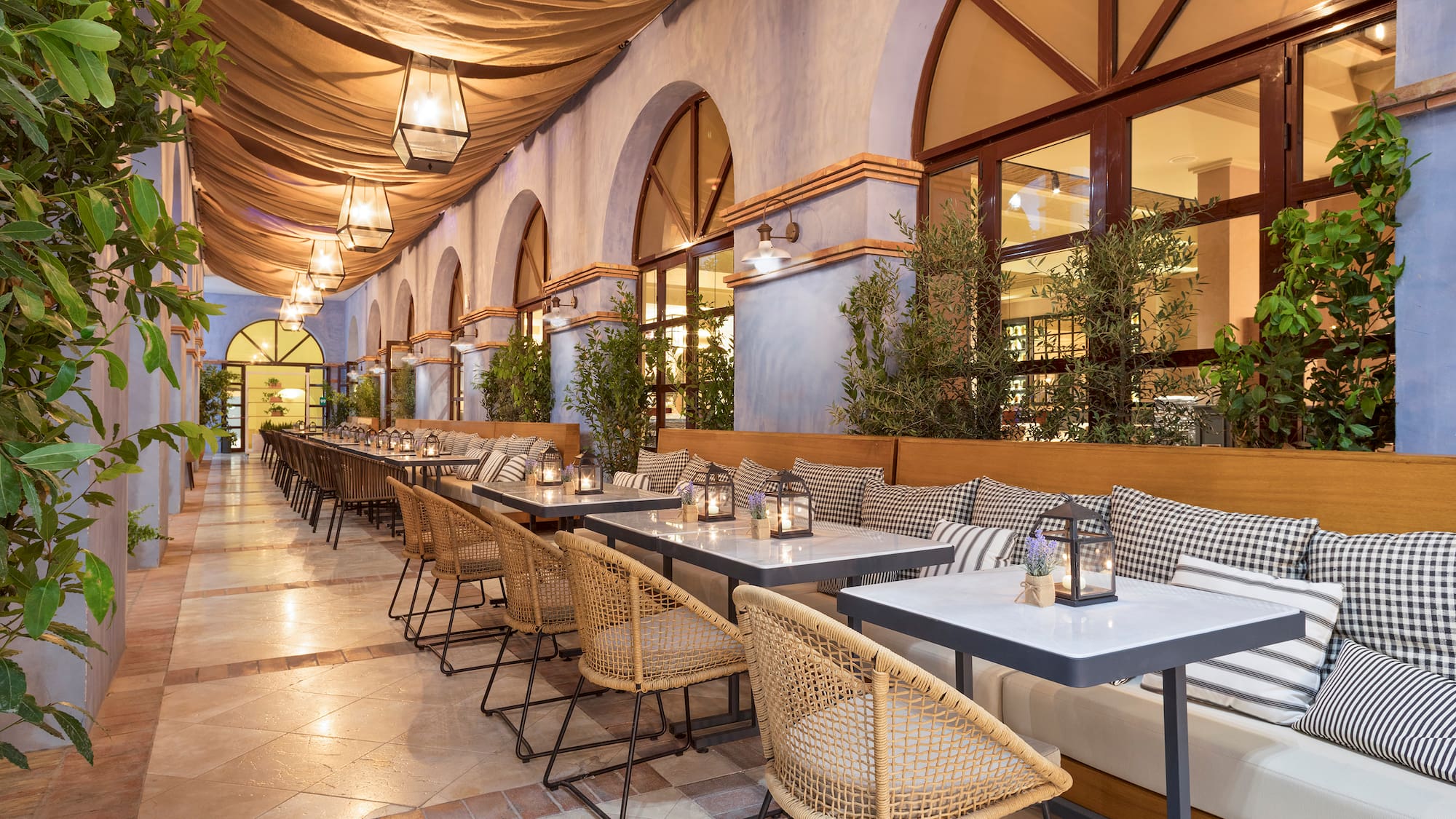 a long outdoor restaurant with tables and chairs