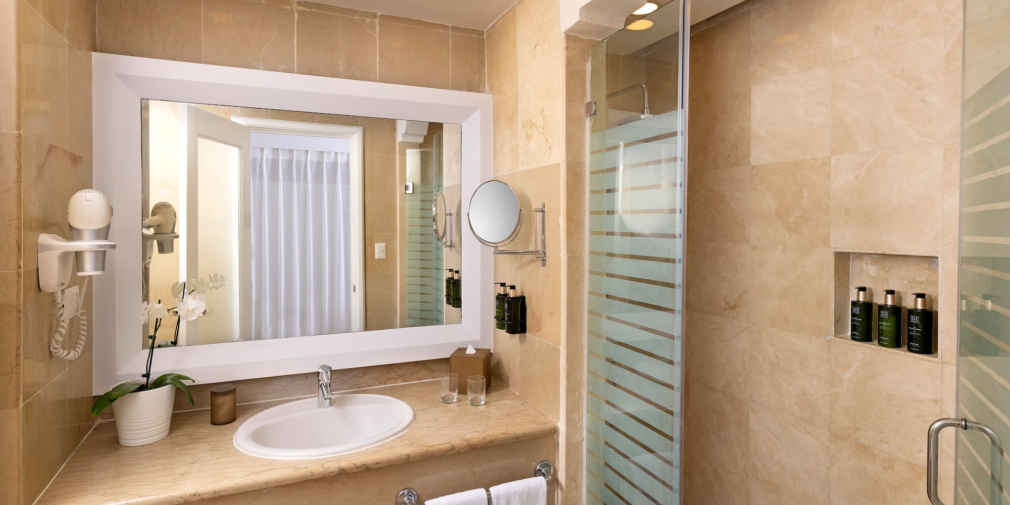 a bathroom with a mirror and a shower