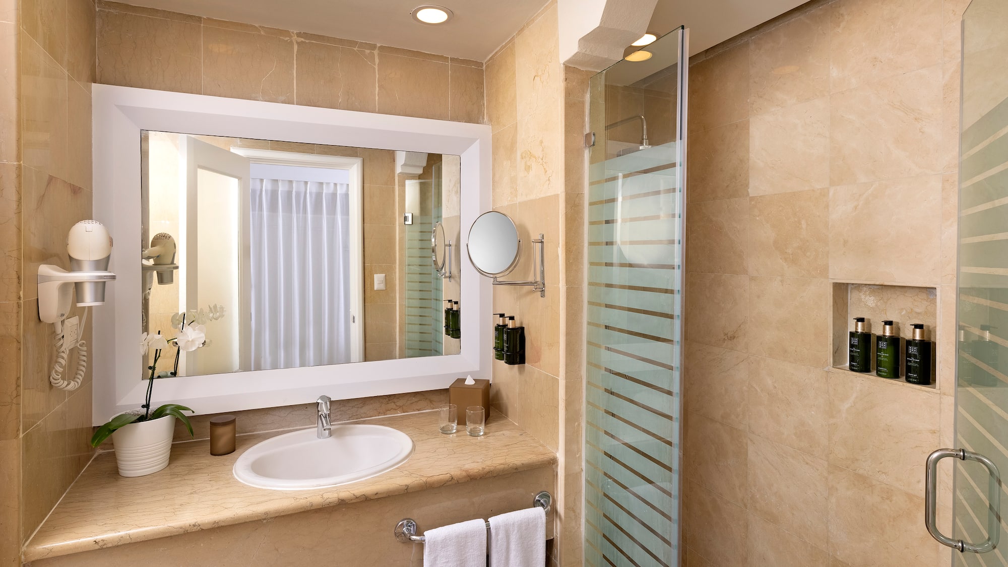 a bathroom with a mirror and a shower