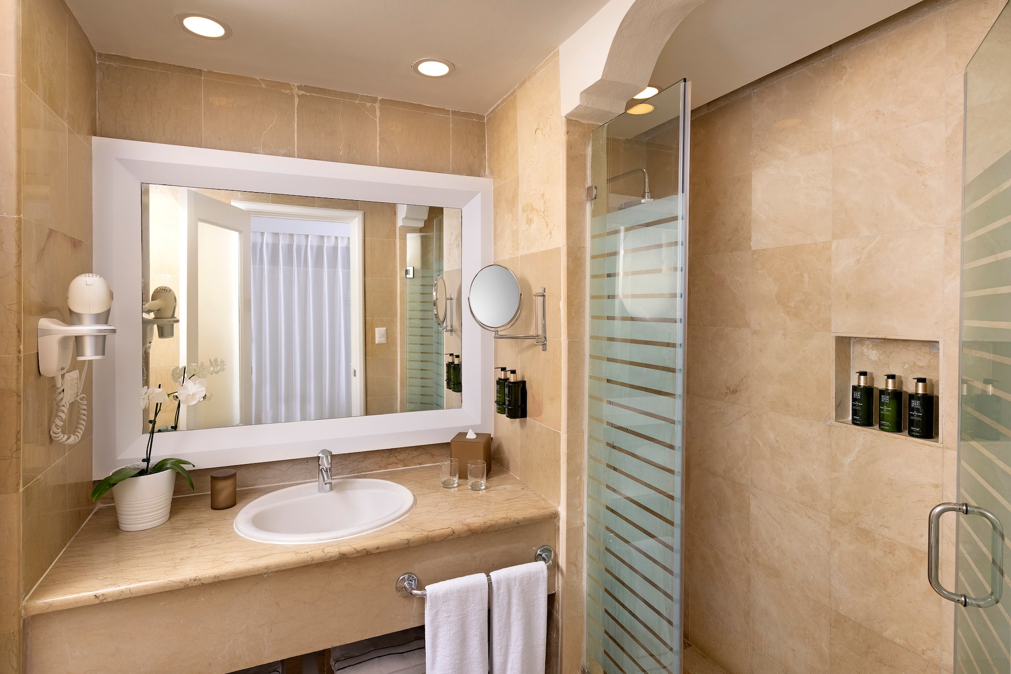 a bathroom with a mirror and a shower