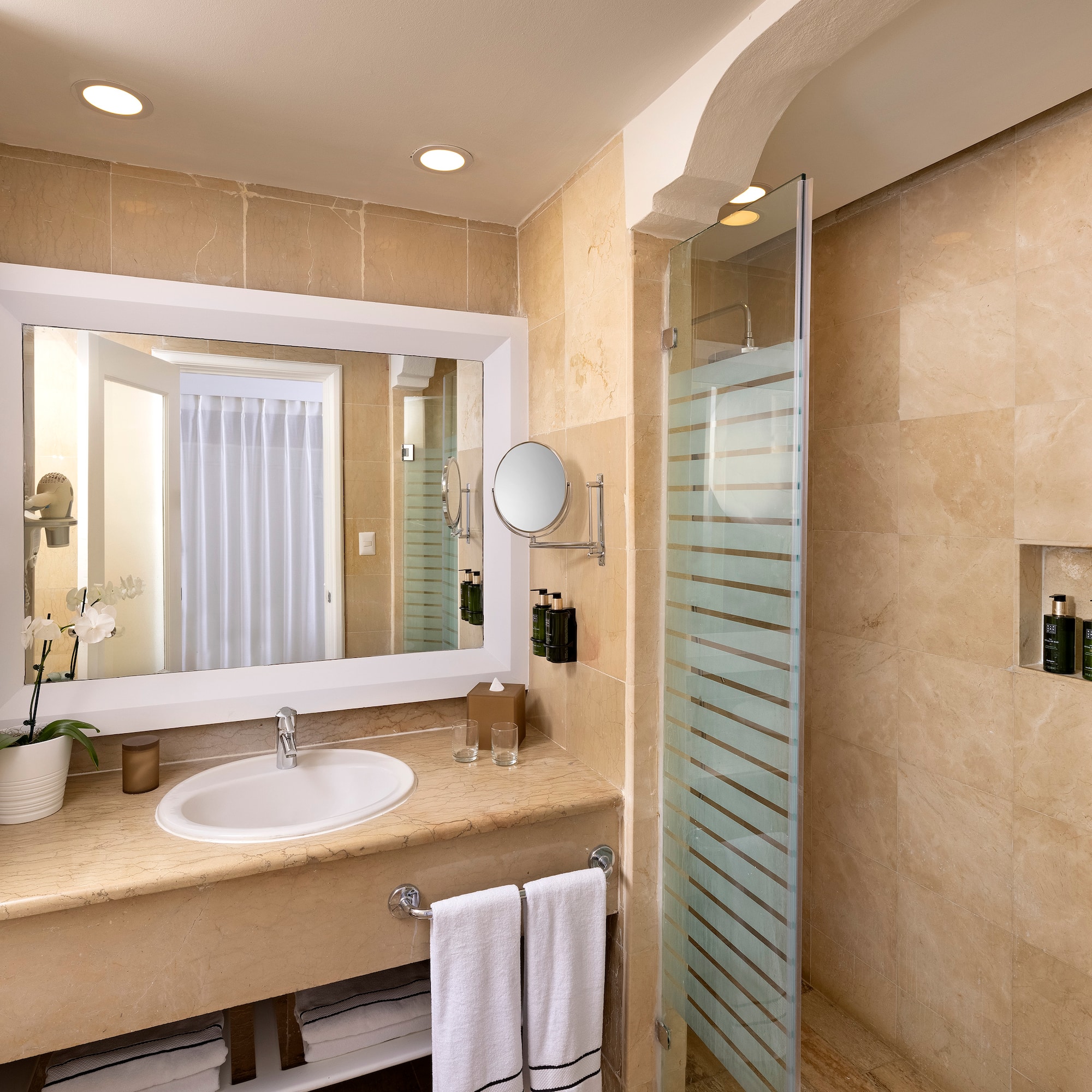 a bathroom with a mirror and a shower