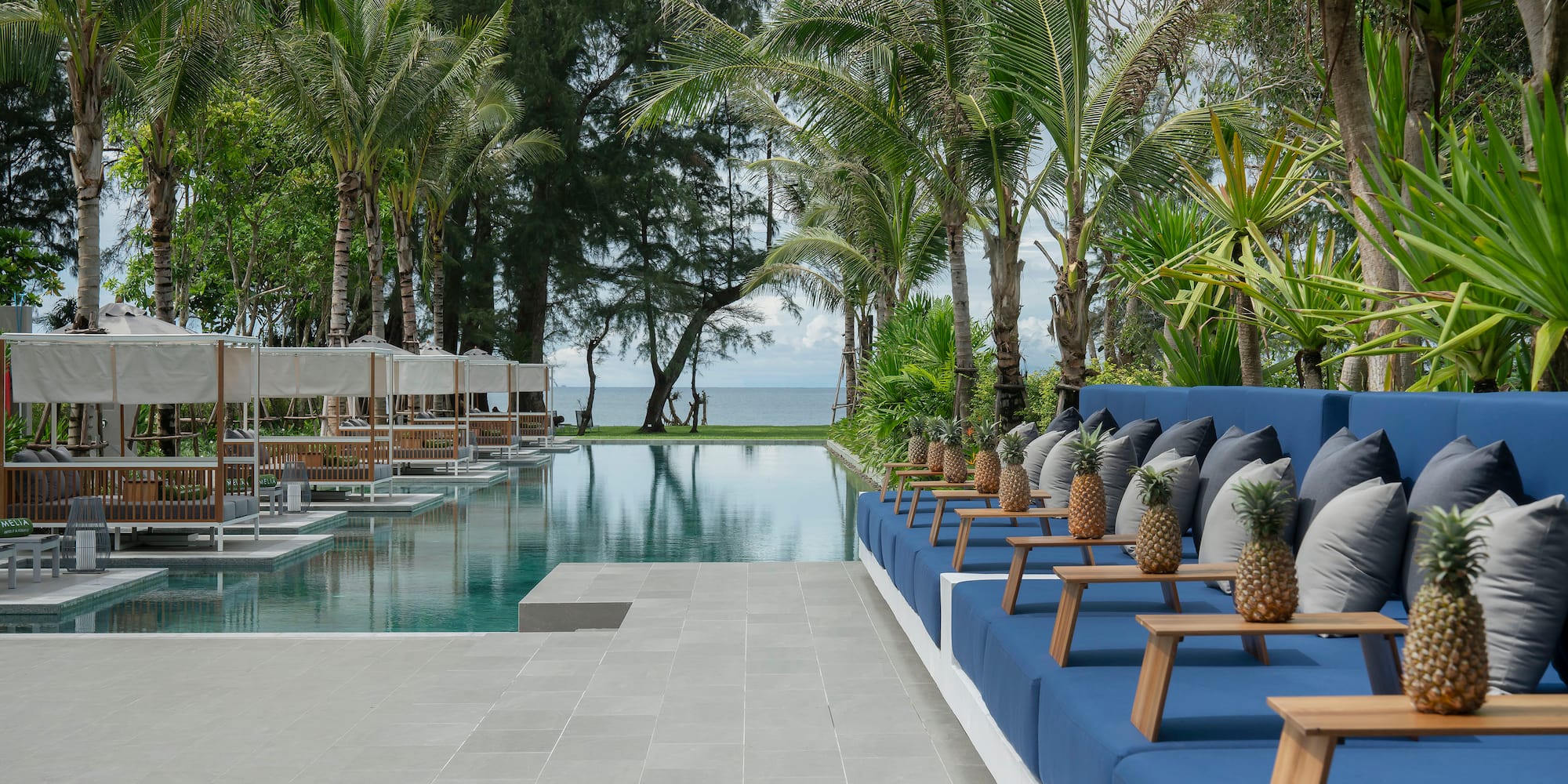 a pool with chairs and trees