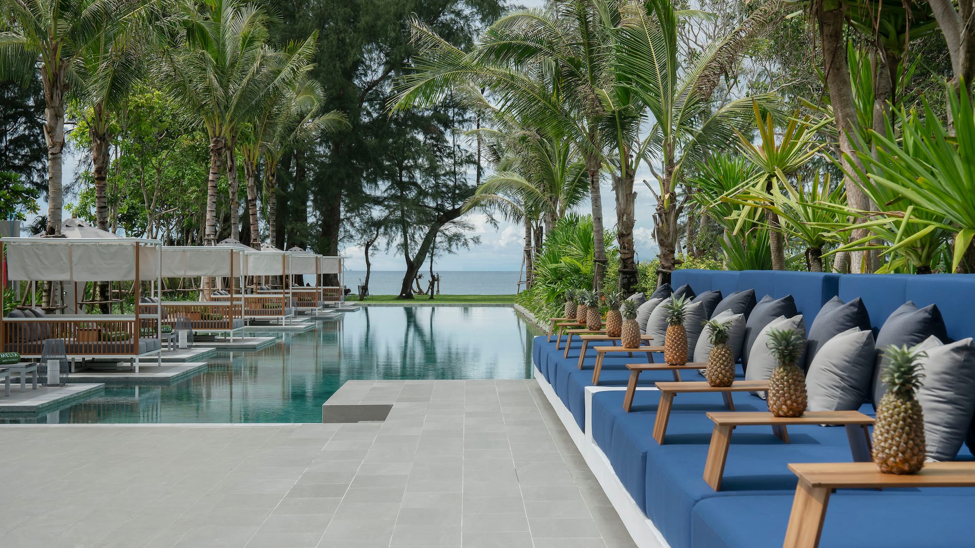 a pool with chairs and trees