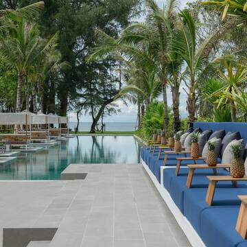 a pool with chairs and trees