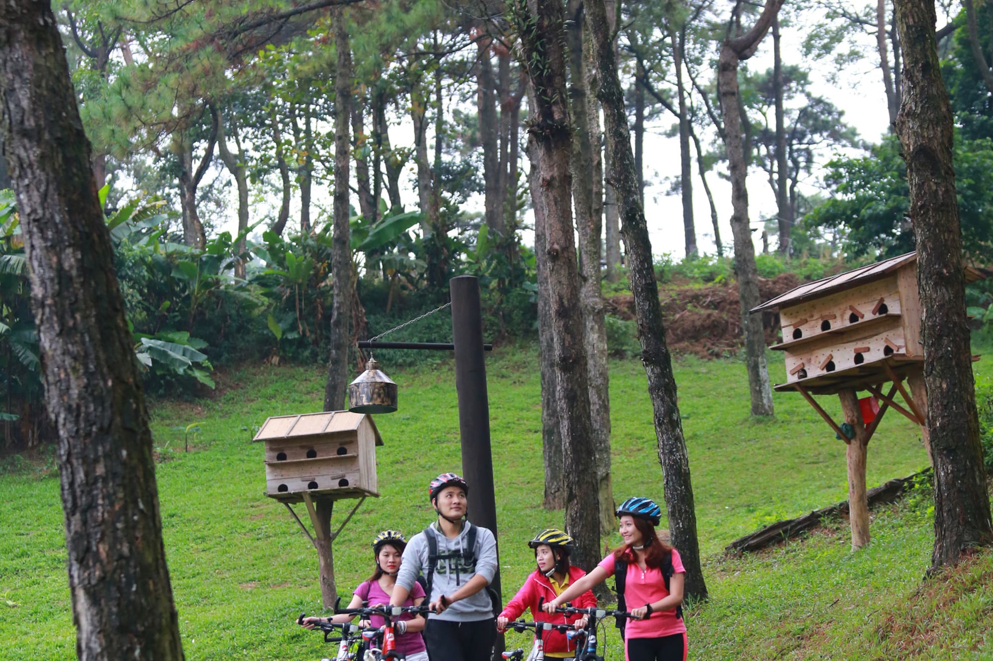 a group of people with bicycles in a park