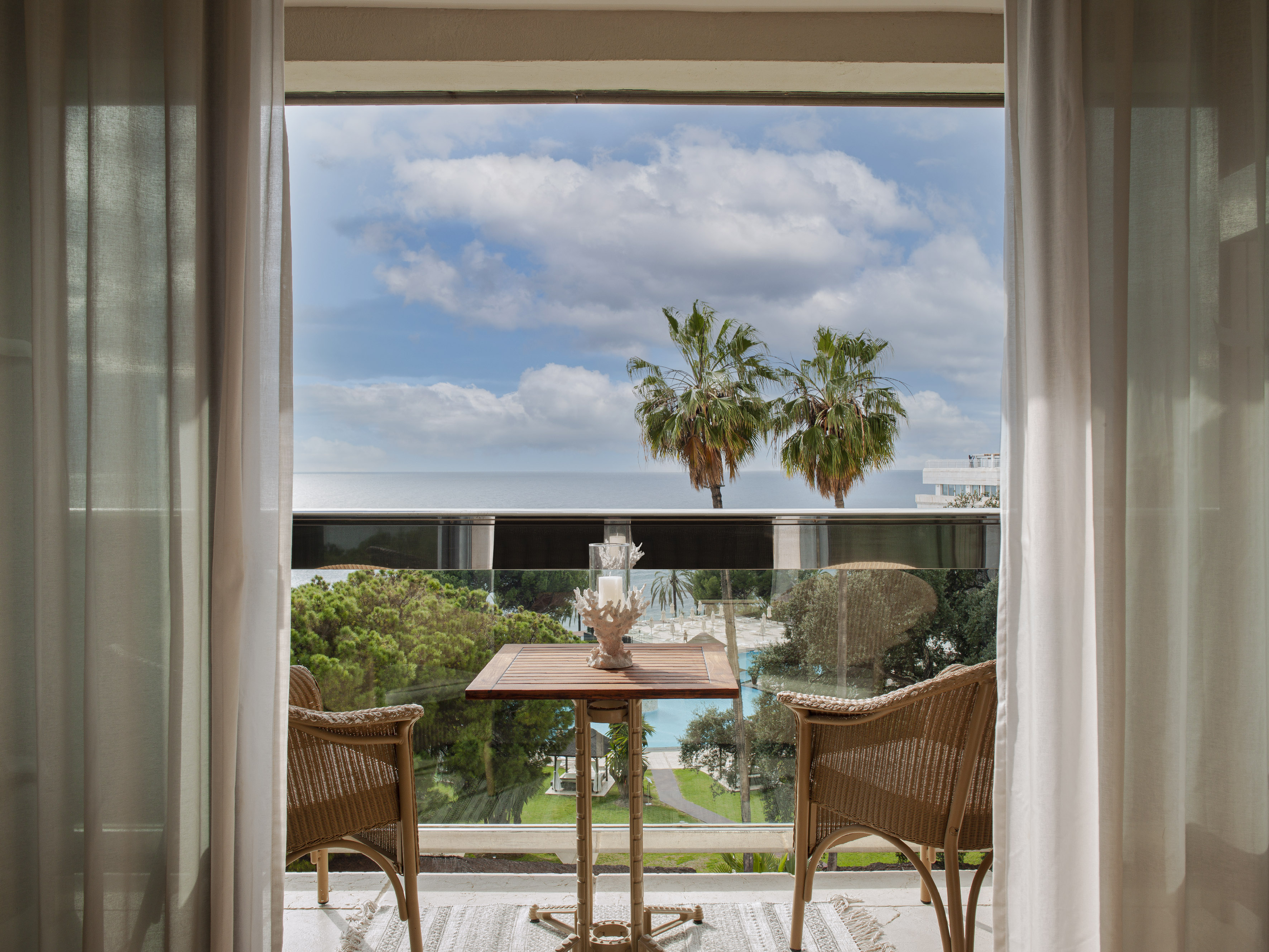 a table and chairs outside a window