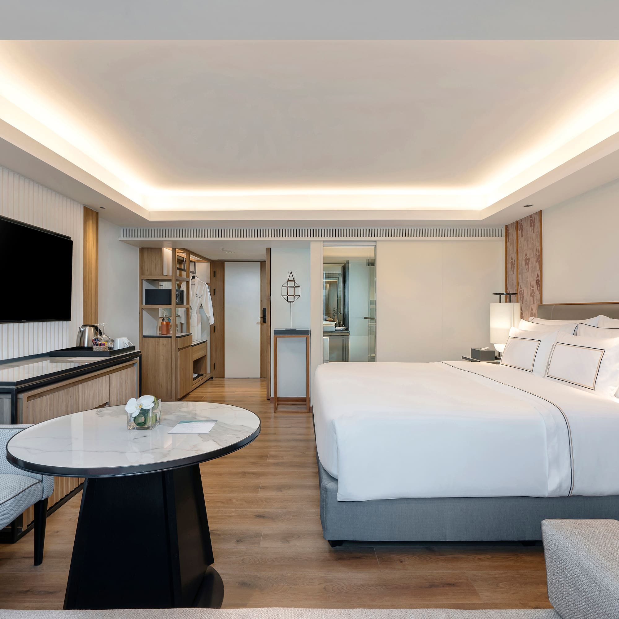 a room with a bed and a television