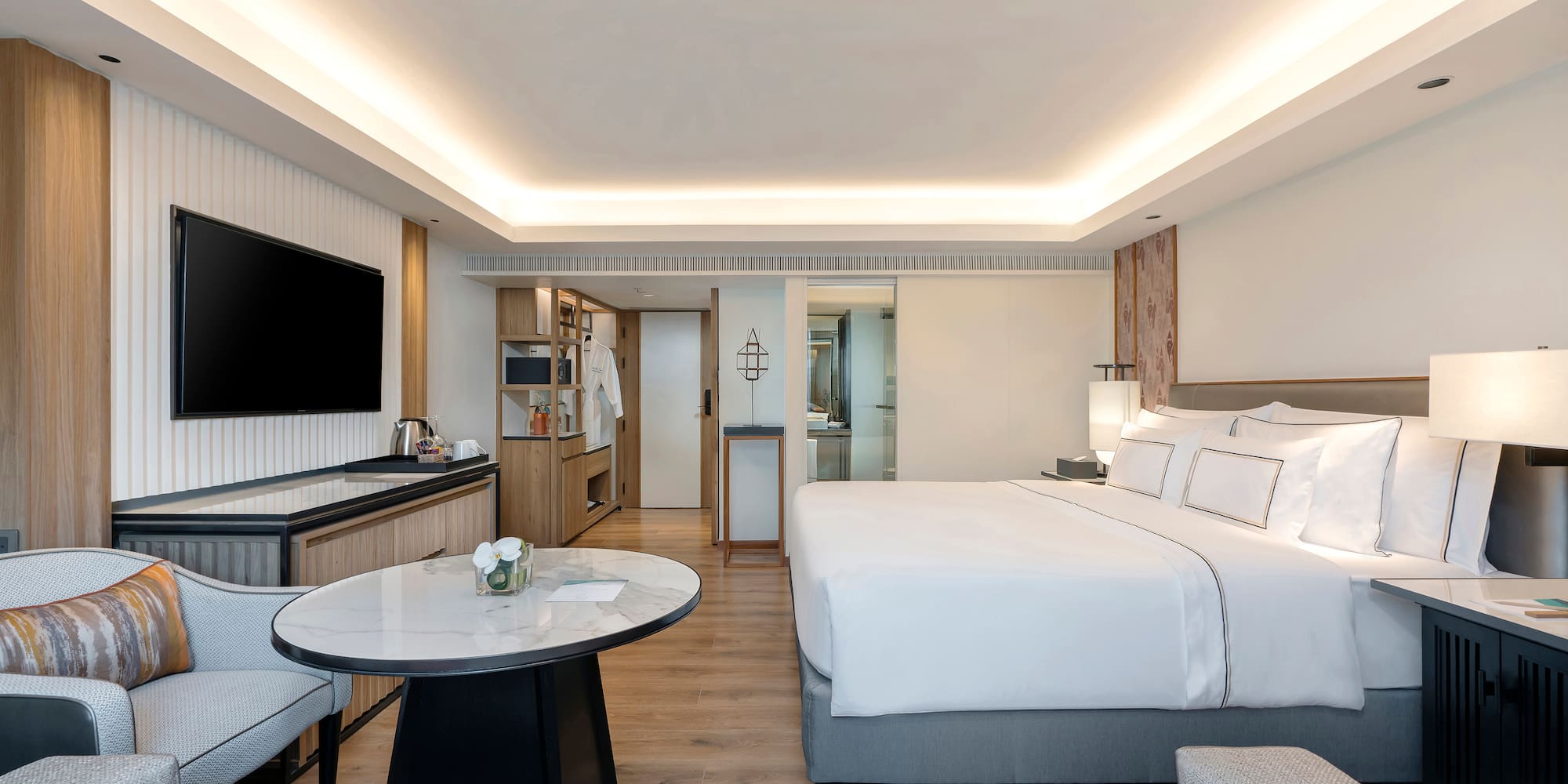 a room with a bed and a television