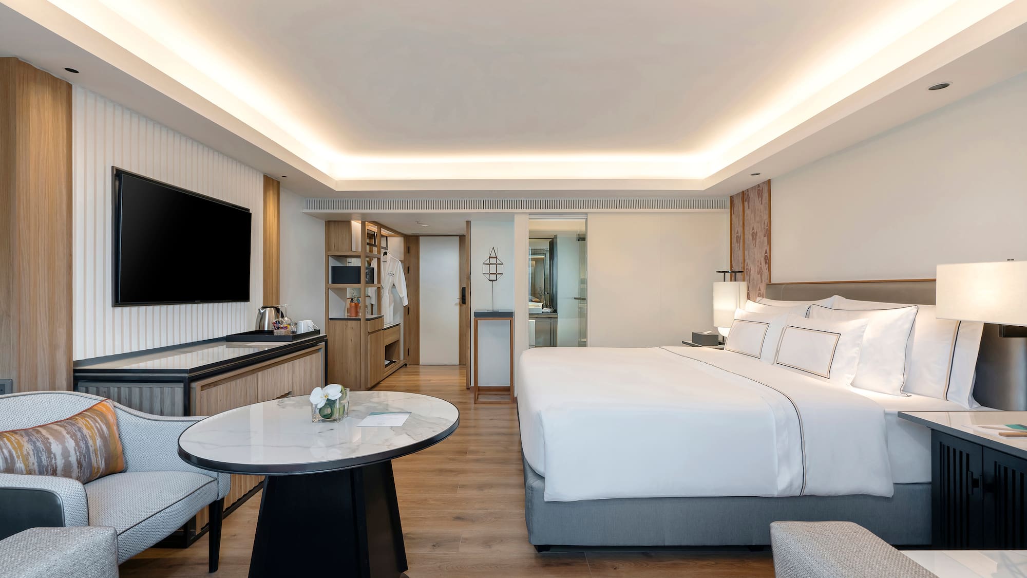 a room with a bed and a television