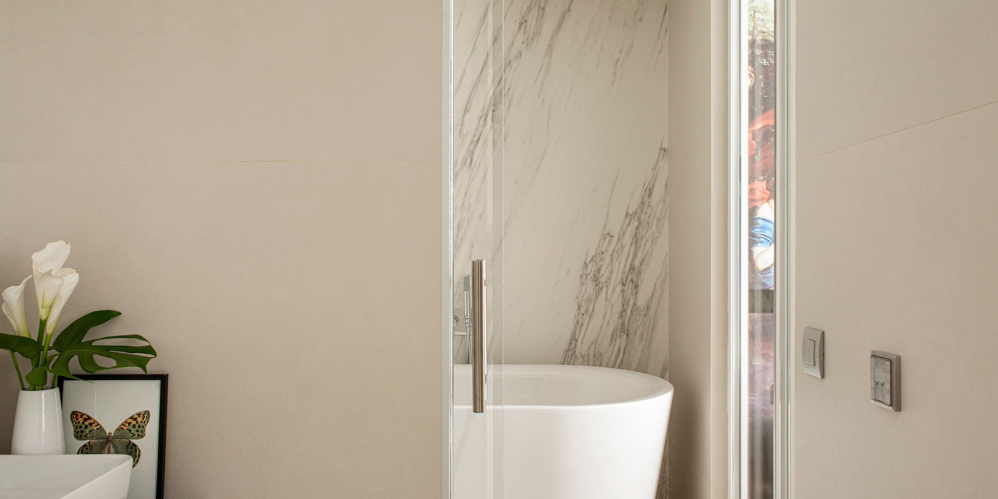 a bathroom with a tub and a glass door