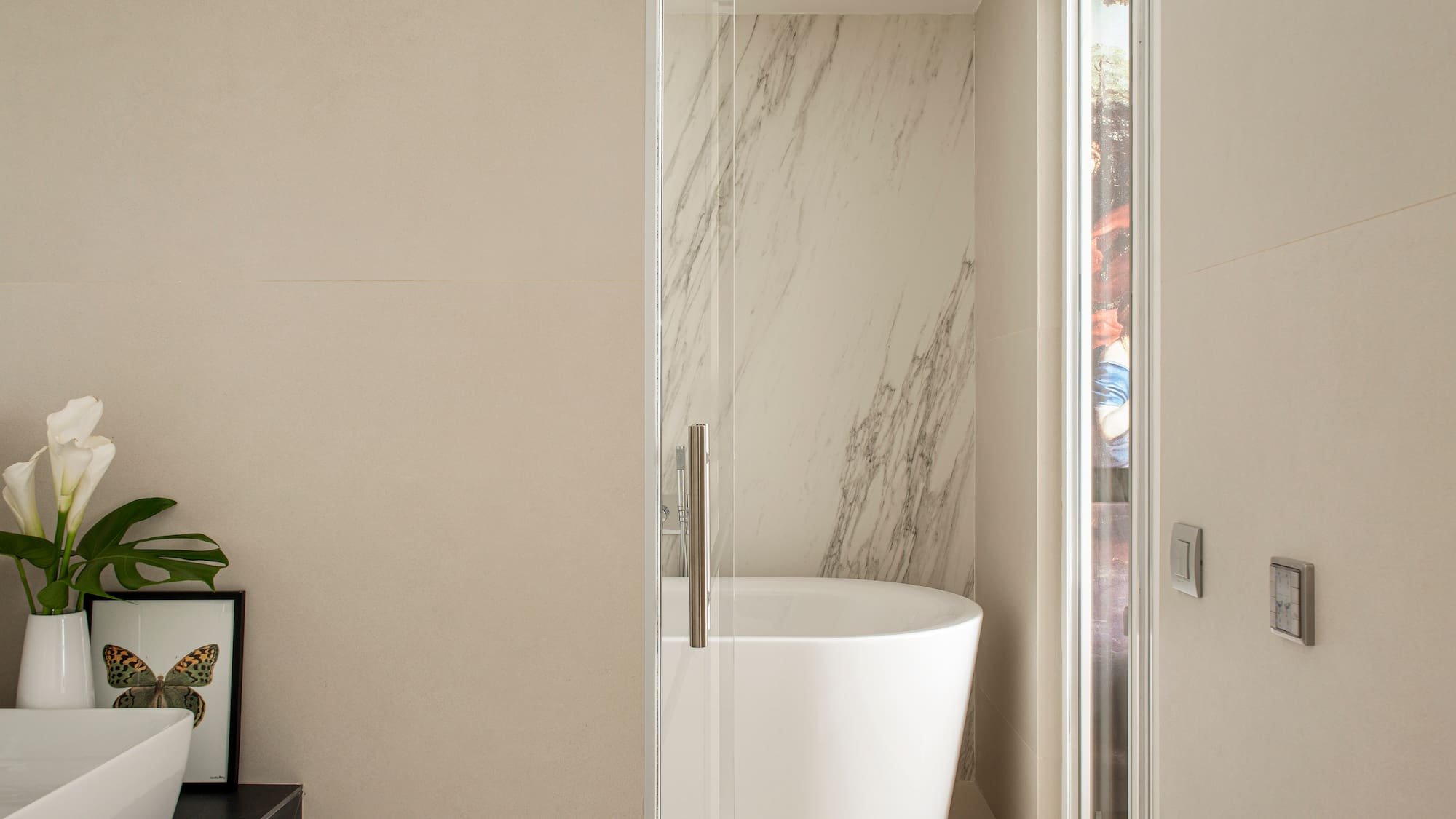 a bathroom with a tub and a glass door