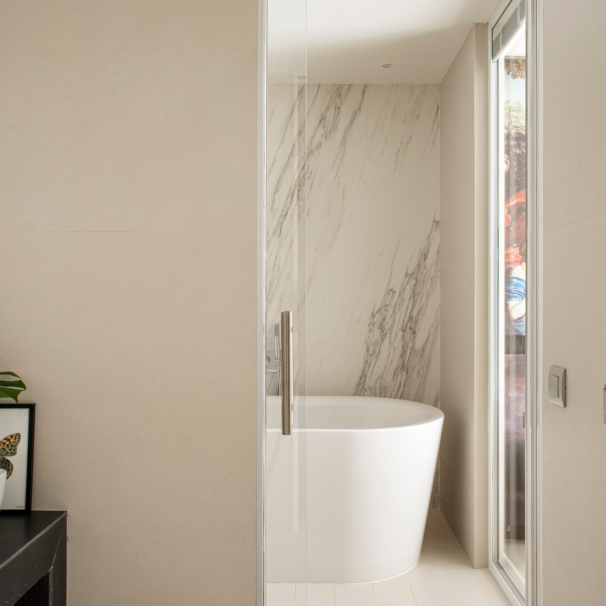 a bathroom with a tub and a glass door