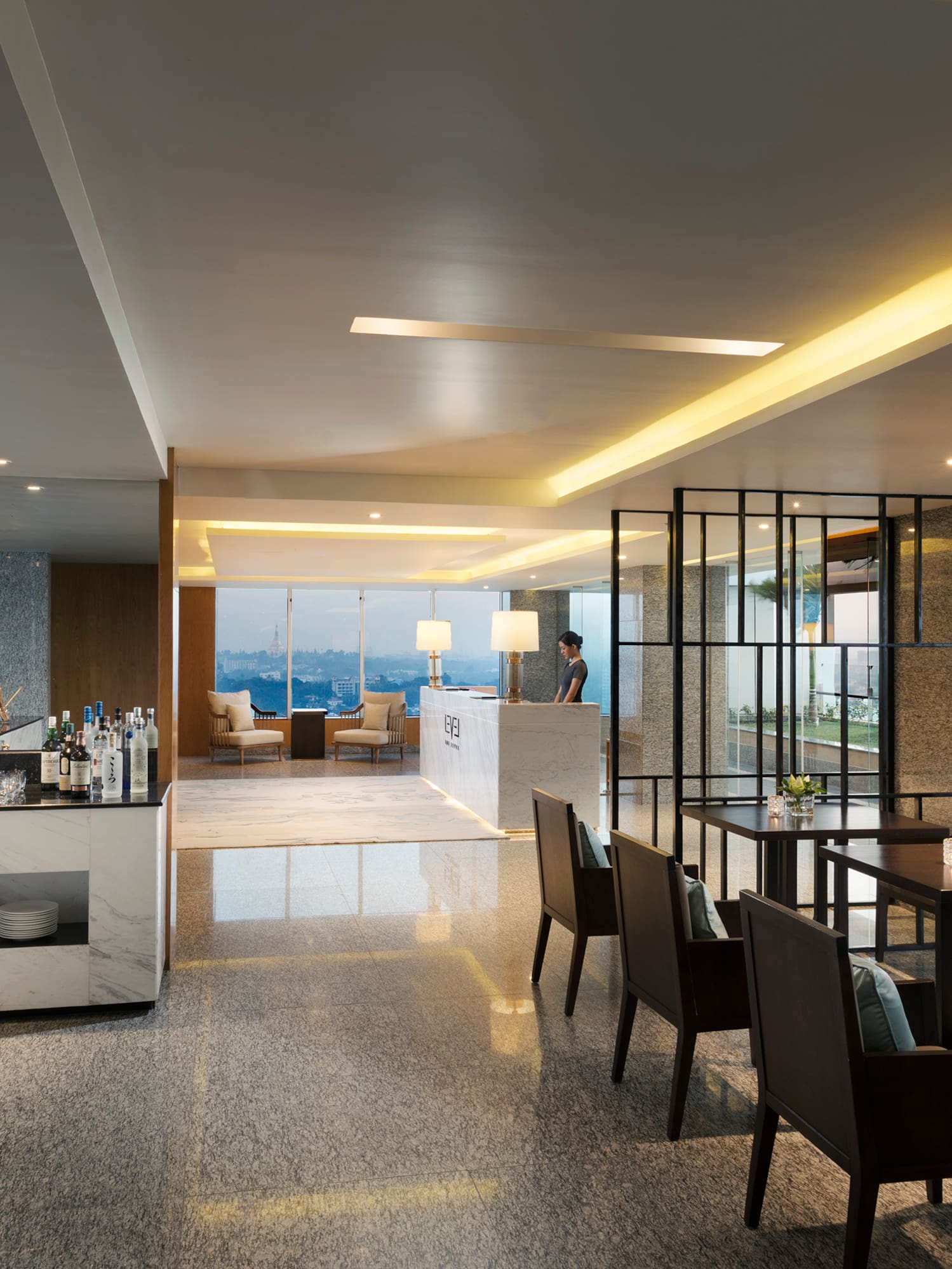 a room with a bar and chairs