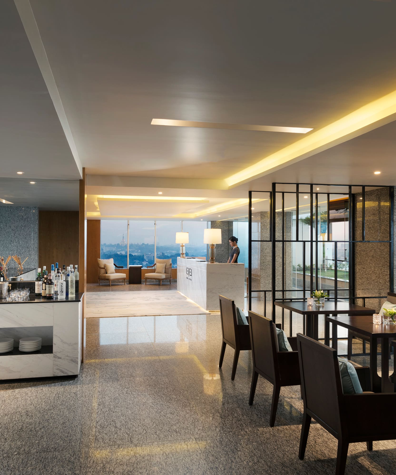 a room with a bar and chairs