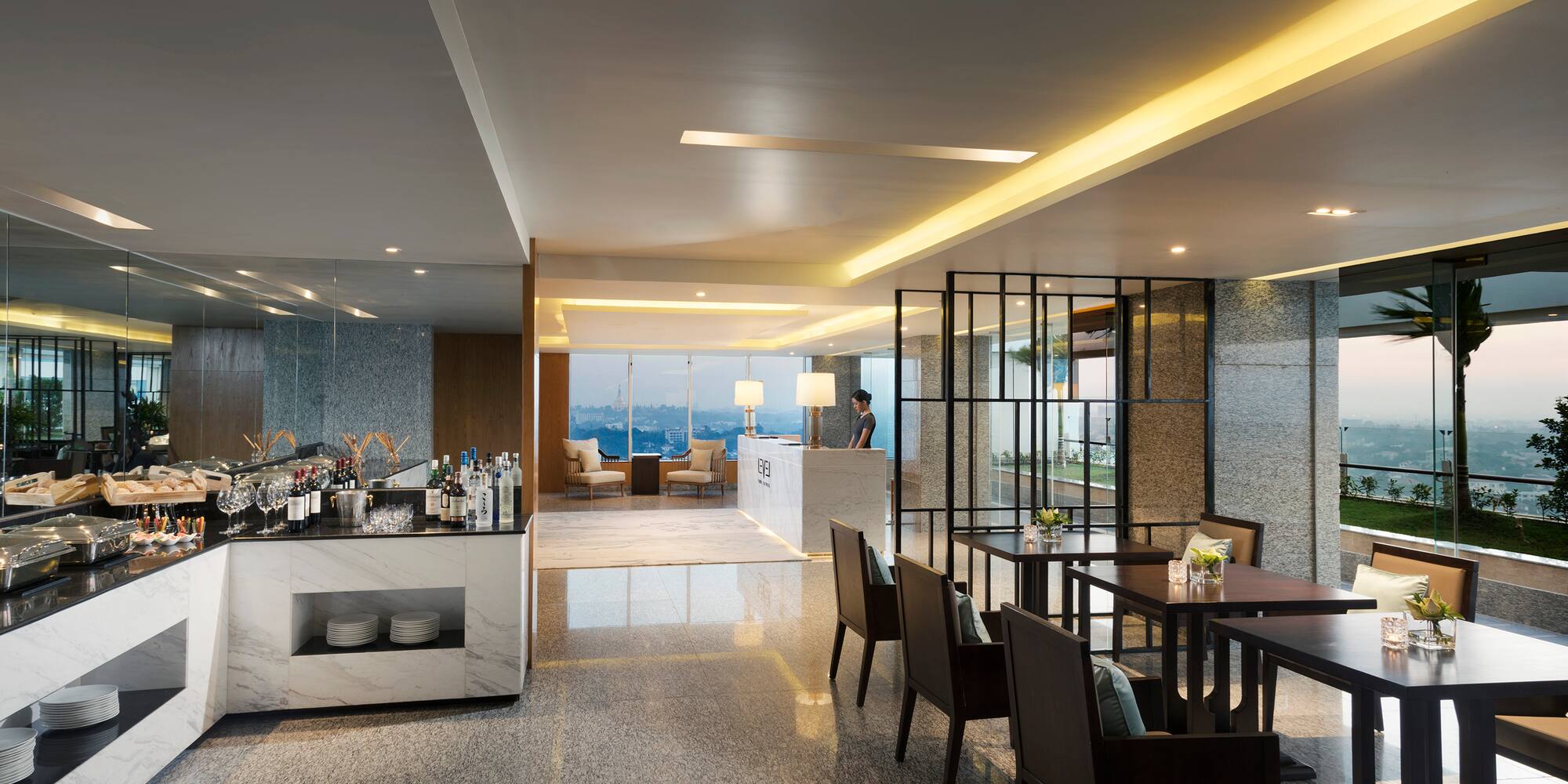 a room with a bar and chairs