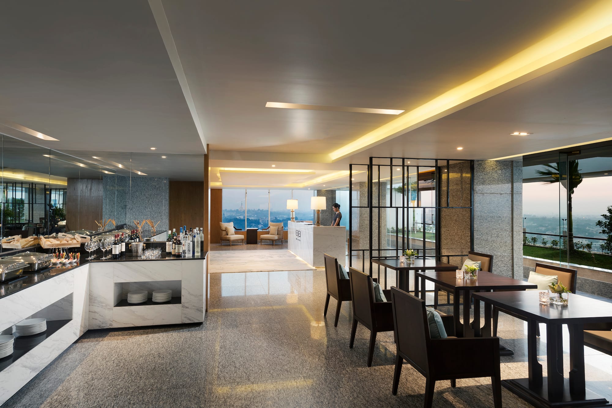 a room with a bar and chairs