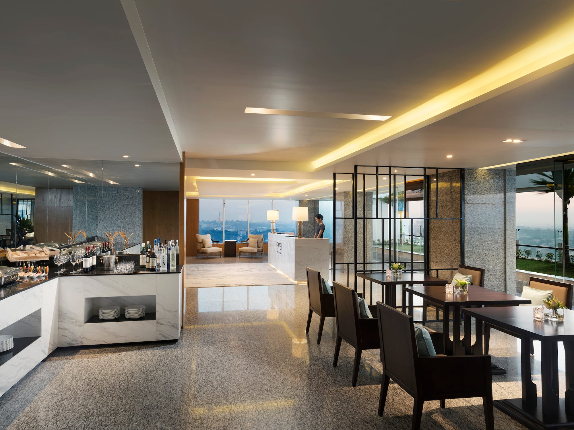 a room with a bar and chairs