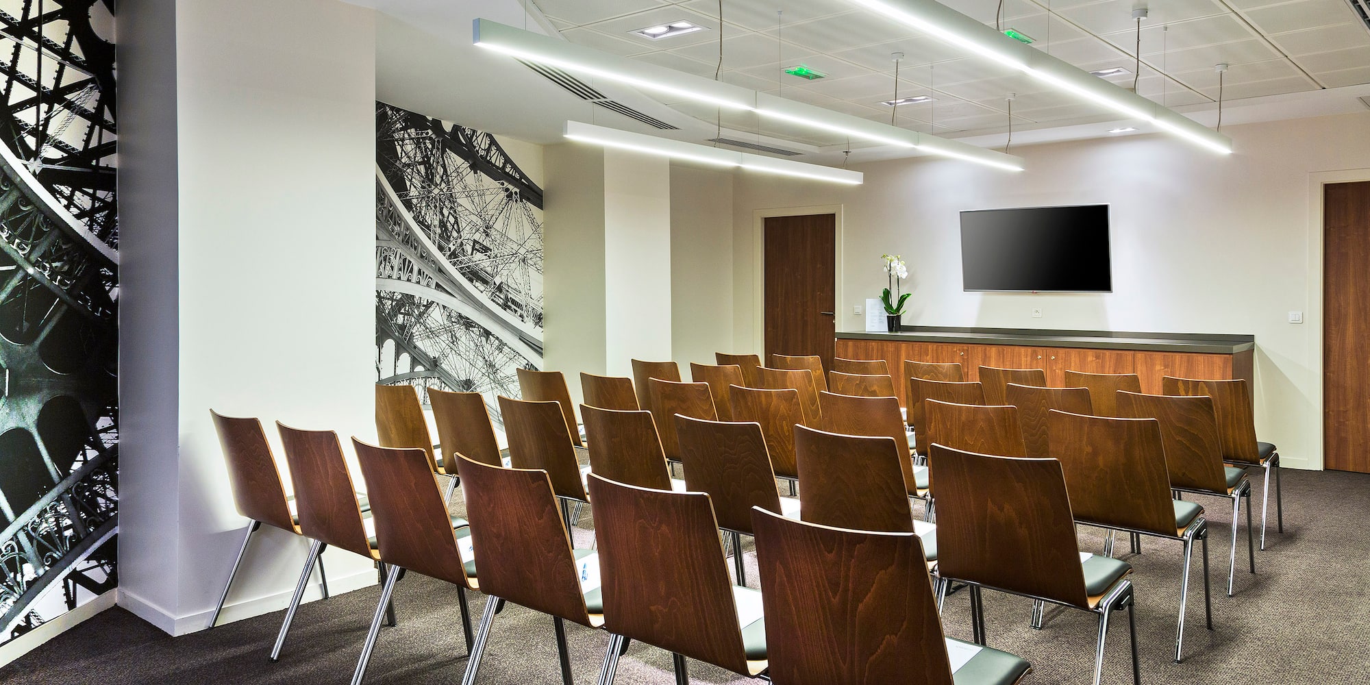 a room with chairs and a television