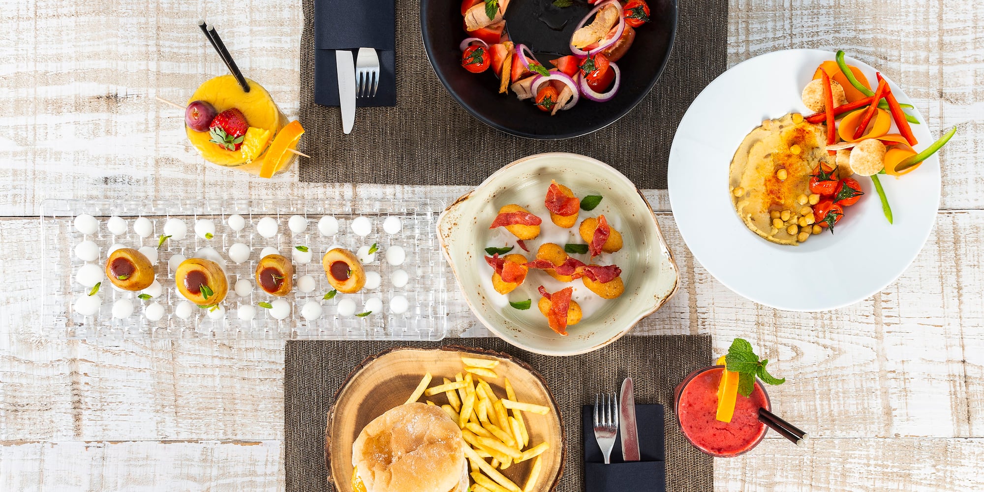 a table with plates of food and drinks